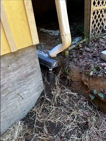 Downspout connected to underground drainage pipe by Bulldog Land Management