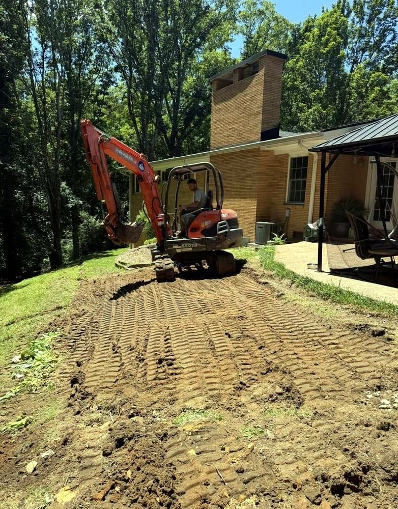 Bulldog Land Management crew grading a backyard site with an excavator